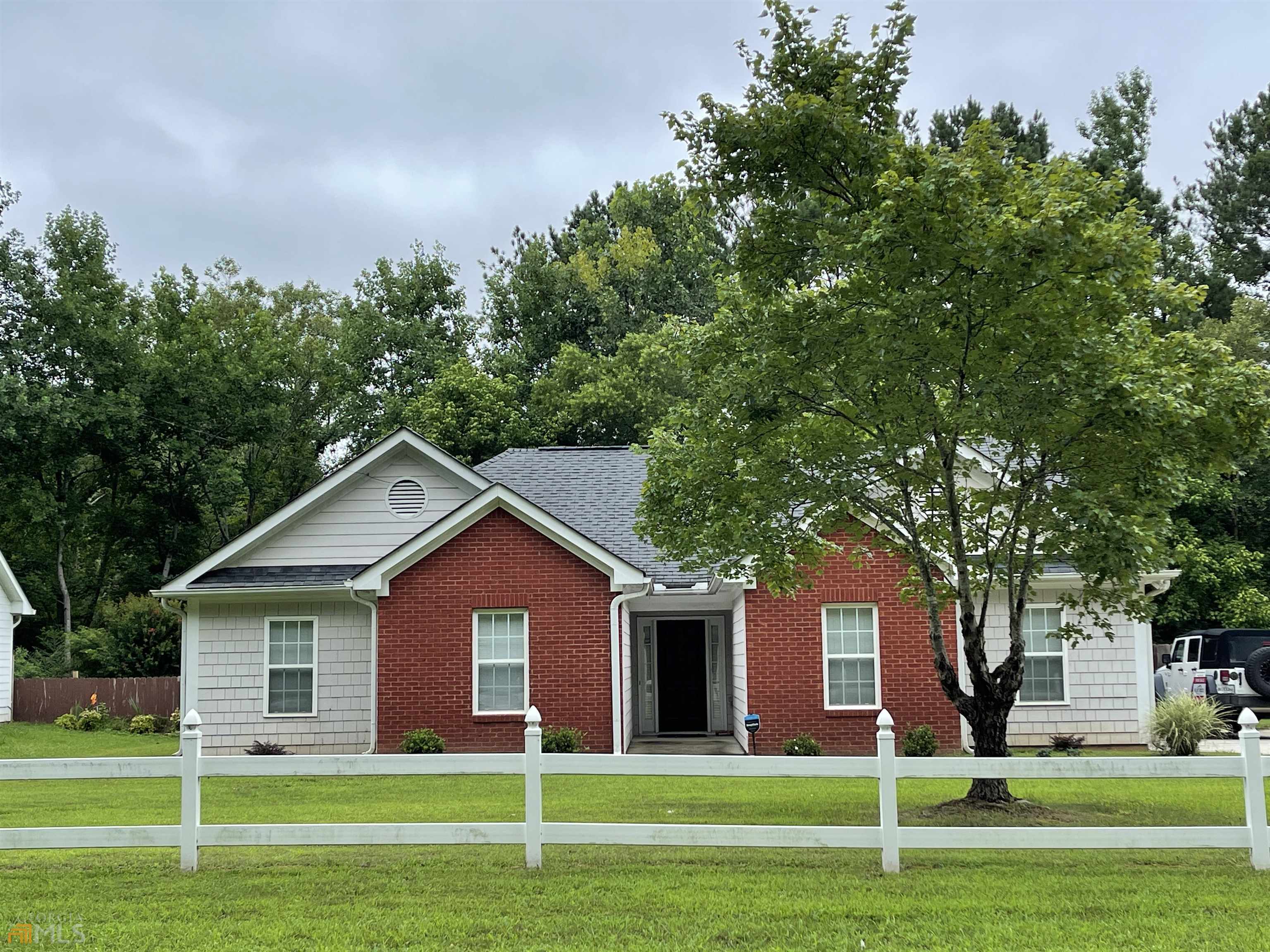 465 Hunnicut Road Southeast Mableton, GA 30126 - Photo 1 of 1 a front view of a house with a yard and trees