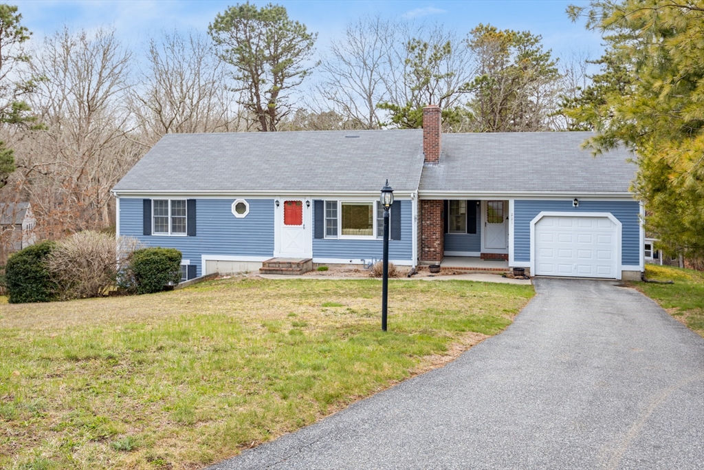 221 Camelback Road Barnstable, MA 02648 - Photo 1 of 31 a front view of house with yard and trees in the background