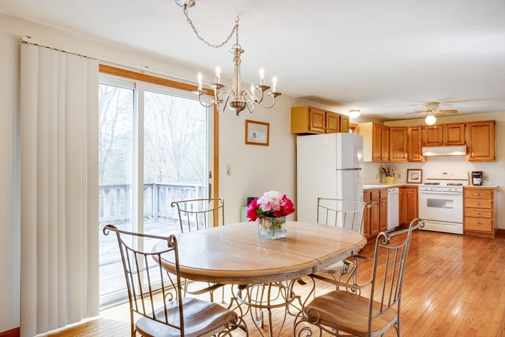 221 Camelback Road Barnstable, MA 02648 - Photo 11 of 31 a view of a dining room with furniture and a chandelier