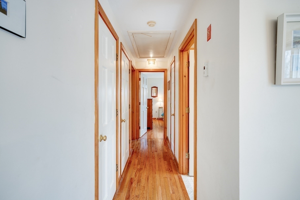 221 Camelback Road Barnstable, MA 02648 - Photo 16 of 31 a view of a hallway with wooden floor and staircase