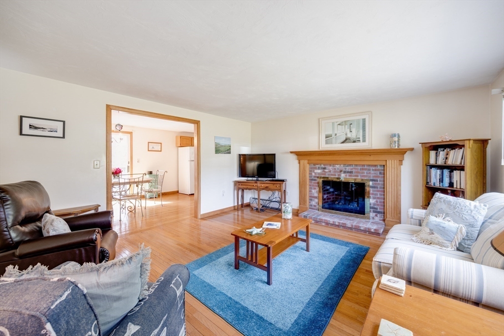 221 Camelback Road Barnstable, MA 02648 - Photo 5 of 31 a living room with furniture a rug and a fireplace