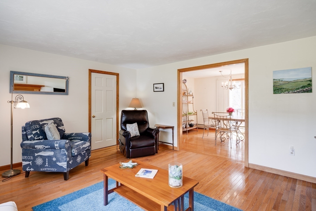 221 Camelback Road Barnstable, MA 02648 - Photo 8 of 31 a living room with furniture and a table with wooden floor