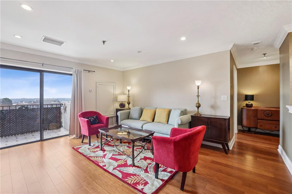300 Johnson Ferry Road, Unit B804 Sandy Springs, GA 30328 - Photo 13 of 37 a living room with furniture a wooden floor and next to kitchen
