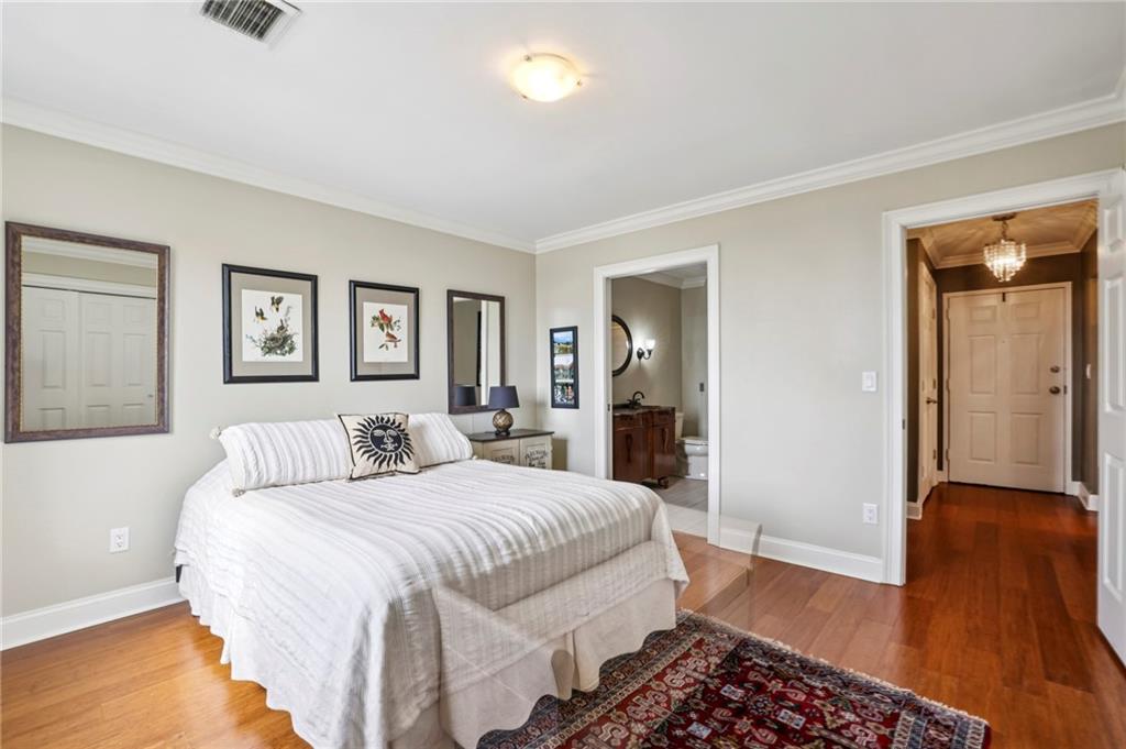 300 Johnson Ferry Road, Unit B804 Sandy Springs, GA 30328 - Photo 15 of 37 a spacious bedroom with a bed and wooden floor