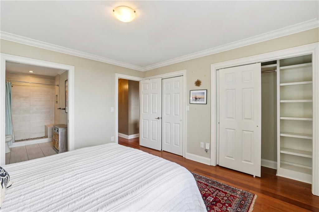 300 Johnson Ferry Road, Unit B804 Sandy Springs, GA 30328 - Photo 18 of 37 a bedroom with a bed and wooden floor