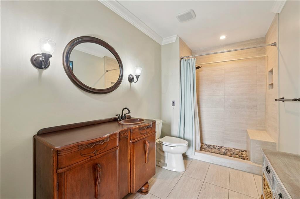 300 Johnson Ferry Road, Unit B804 Sandy Springs, GA 30328 - Photo 20 of 37 a bathroom with a granite countertop sink a toilet a mirror and shower