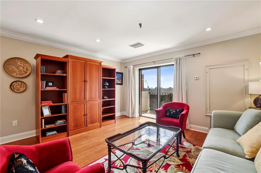 300 Johnson Ferry Road, Unit B804 Sandy Springs, GA 30328 - Photo 22 of 37 a living room with furniture a bookshelf and a window