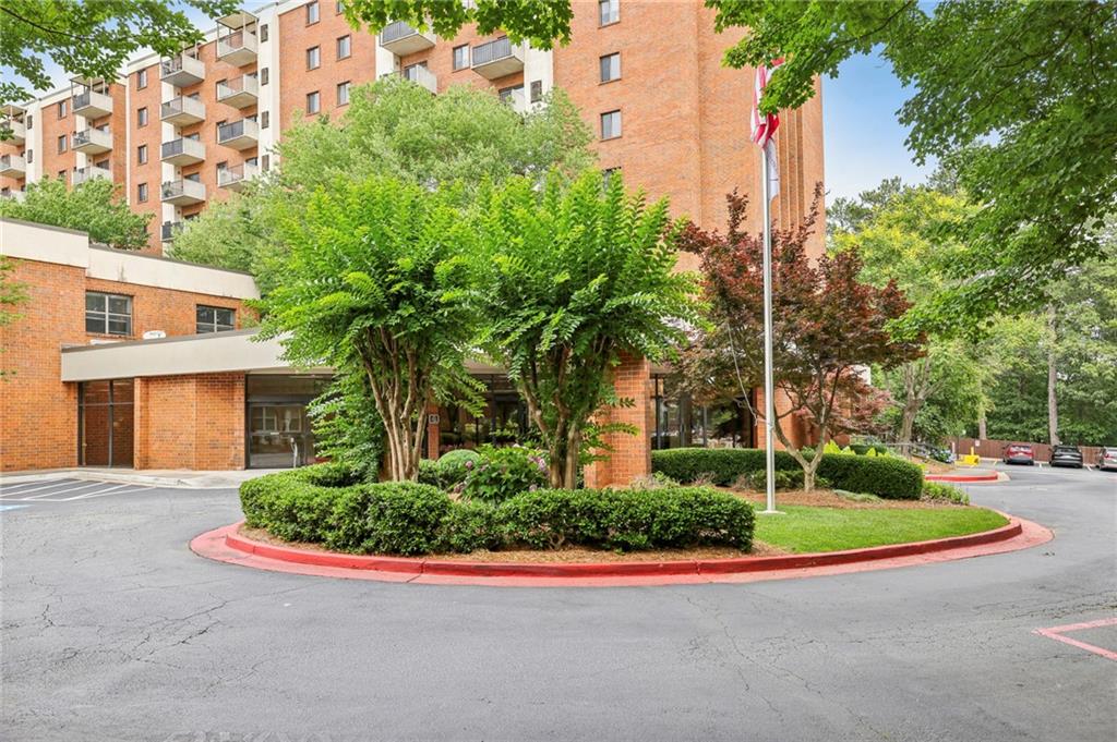 300 Johnson Ferry Road, Unit B804 Sandy Springs, GA 30328 - Photo 34 of 37 a front view of a house with a yard and potted plants