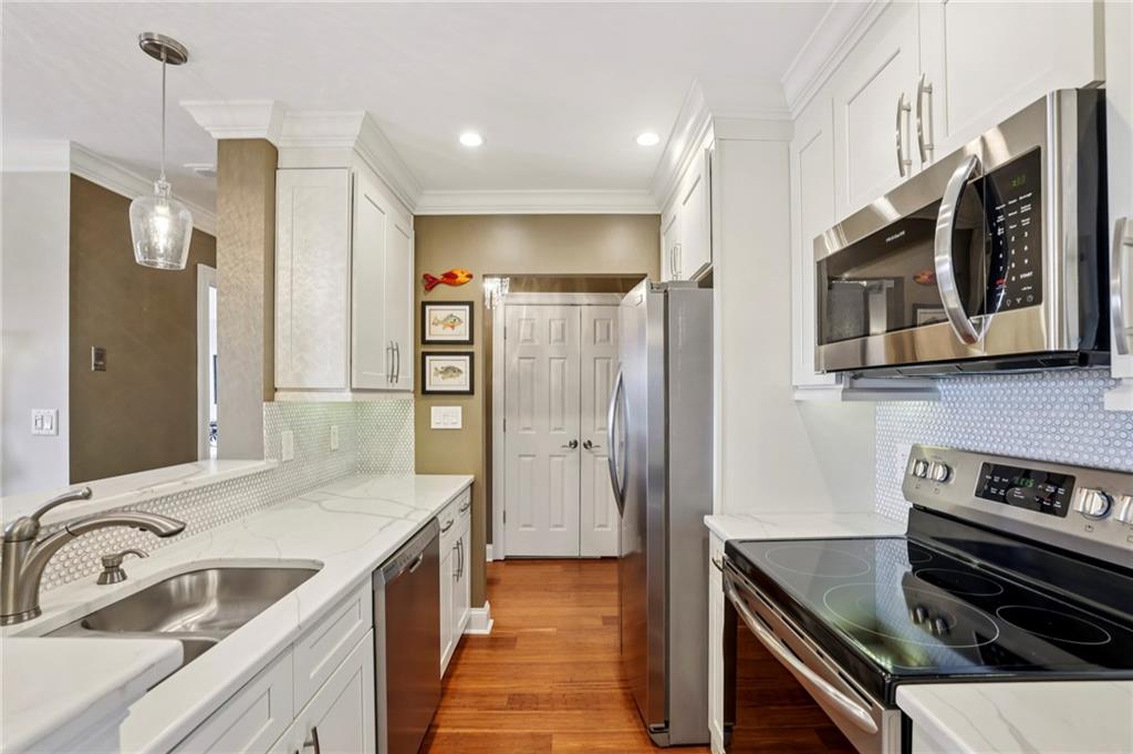 300 Johnson Ferry Road, Unit B804 Sandy Springs, GA 30328 - Photo 7 of 37 a kitchen with stainless steel appliances granite countertop a sink and a refrigerator