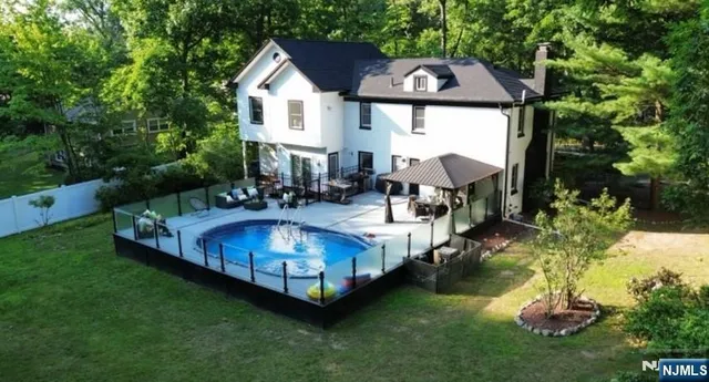 a view of a house with backyard and sitting area