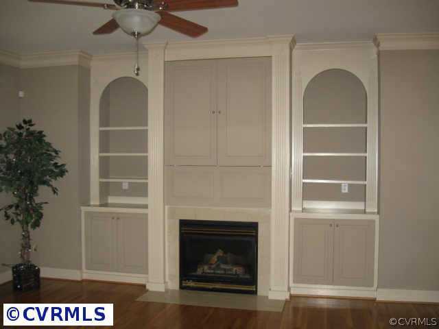 14319 River Road Chesterfield, VA 23838 - Photo 3 of 9 a living room with a fireplace and a potted plant