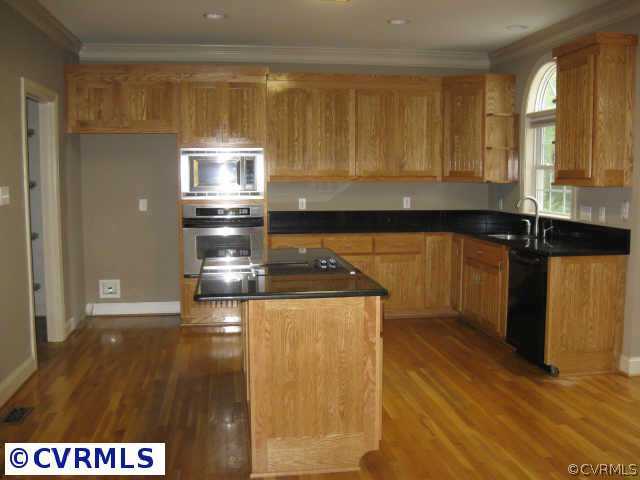 14319 River Road Chesterfield, VA 23838 - Photo 5 of 9 a kitchen with granite countertop a stove a sink and a microwave