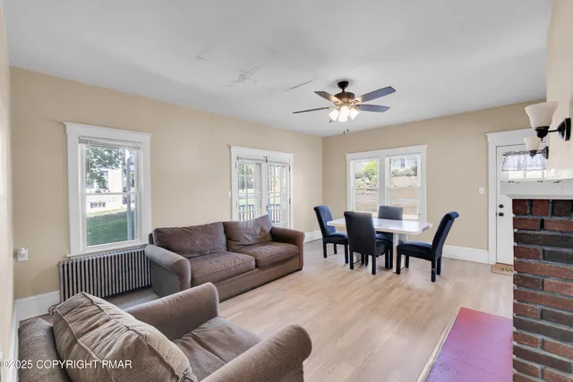 a living room with furniture a chandelier and a window