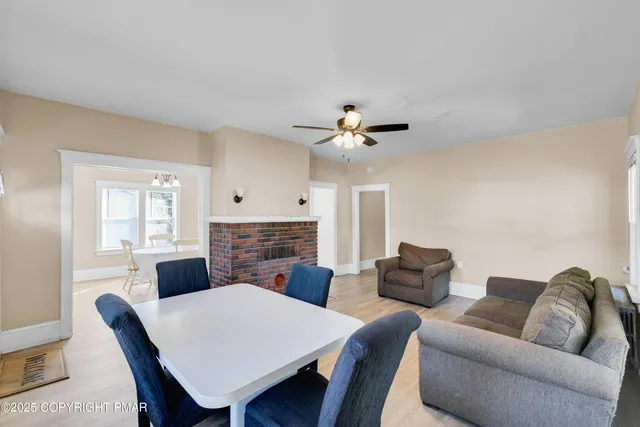 a living room with furniture a fireplace and a table