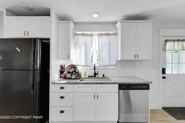 a view of a room with wooden floor staircase and bathroom