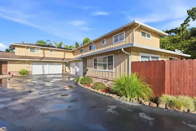 a front view of a house with a garden