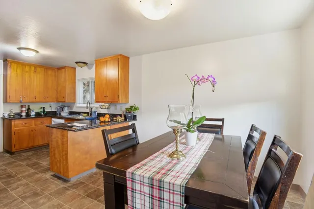 a kitchen with stainless steel appliances granite countertop a sink and a refrigerator