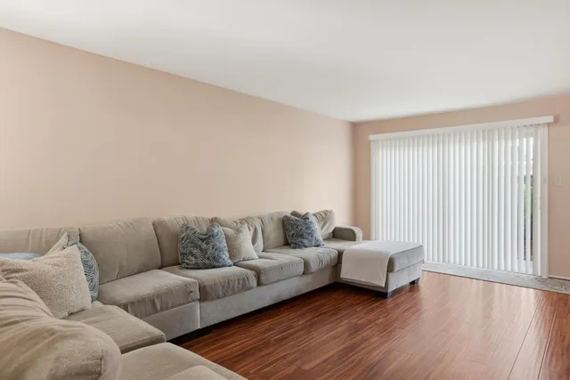 a view of a dining room with furniture a chandelier and wooden floor