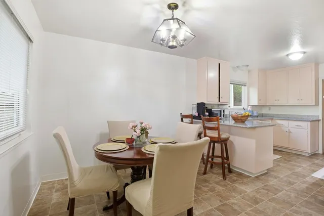 a dining room with furniture and wooden floor