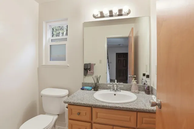 a bathroom with a sink toilet and mirror