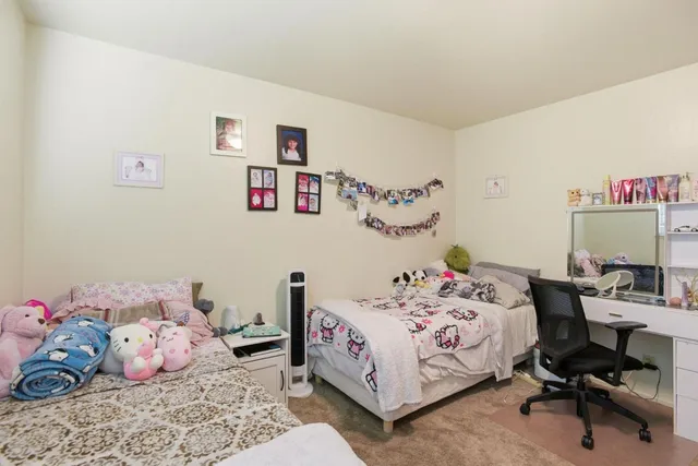 a backyard of a house with fountain table and chairs