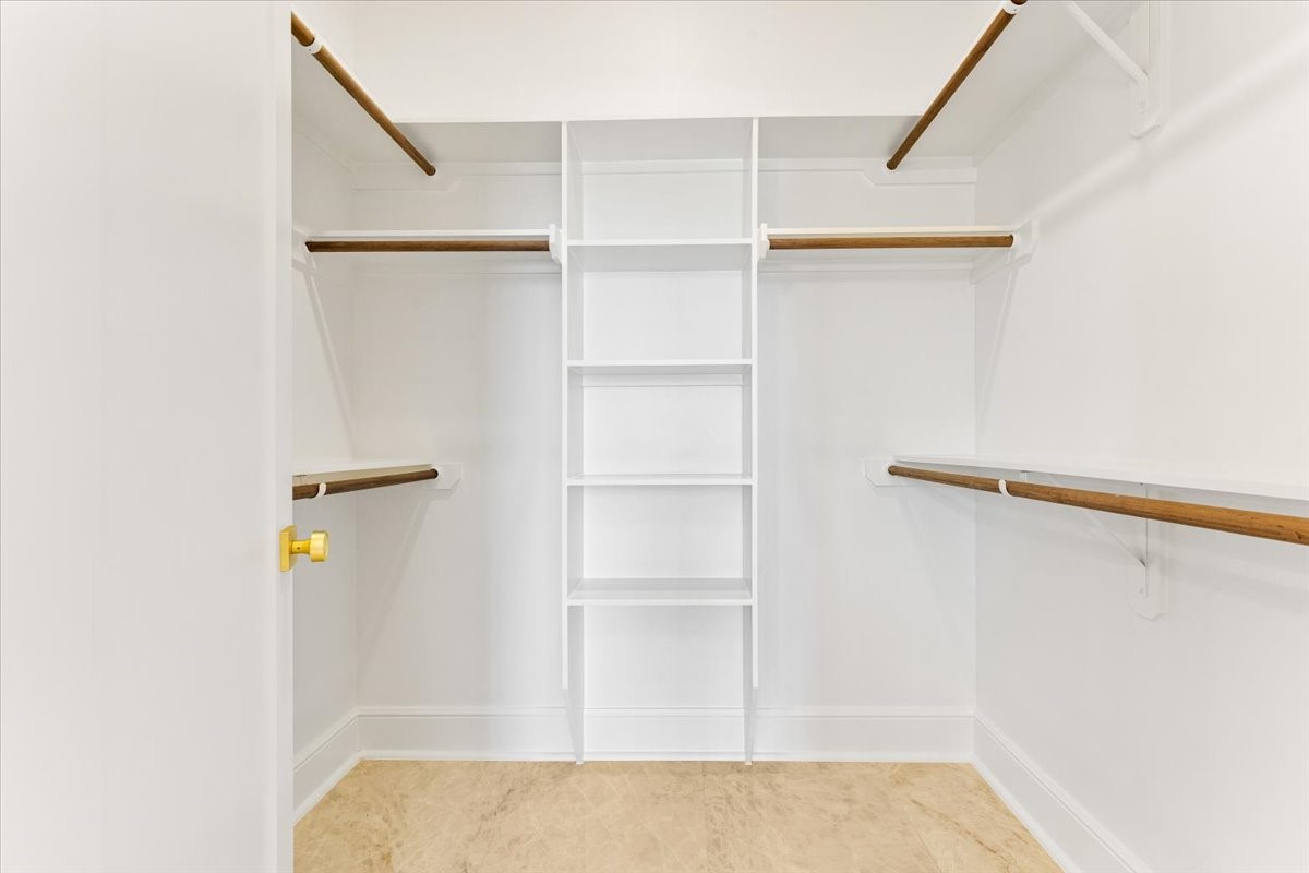 13903 Routt Point Road Needville, TX 77461 - Photo 32 of 43 a view of walk in closet with empty racks