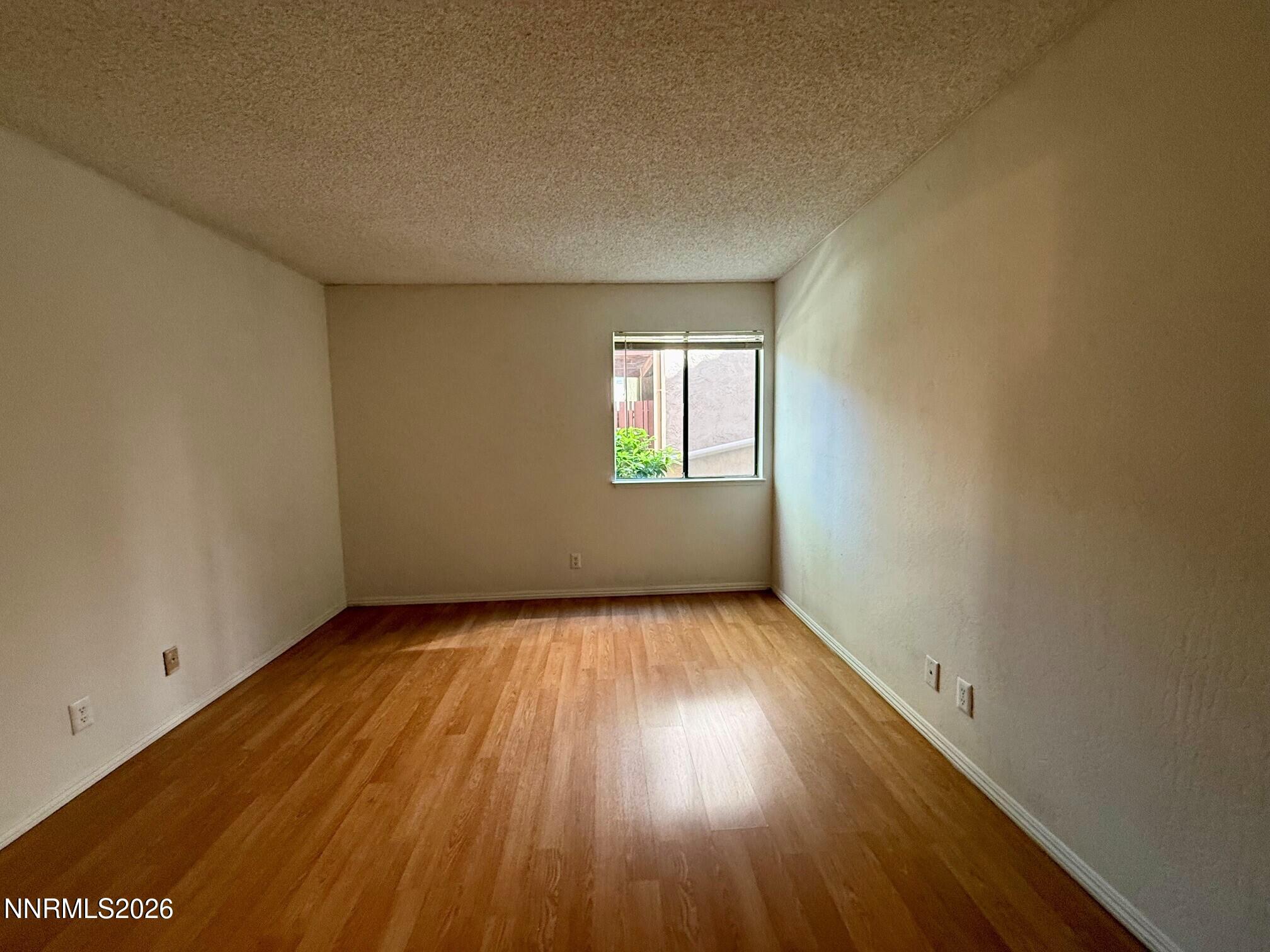 2955 Lakeside Drive, Unit 120 Reno, NV 89509 - Photo 6 of 21 an empty room with wooden floor and windows