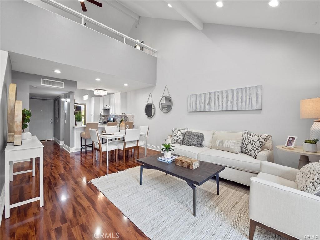 a living room with furniture and a wooden floor