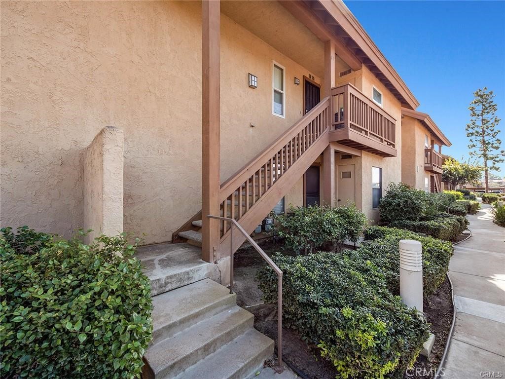 61 Orange Blossom Irvine, CA 92618 - Photo 30 of 40 a front view of building with yard and green space