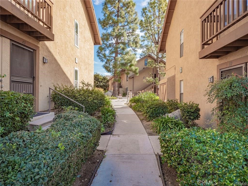 61 Orange Blossom Irvine, CA 92618 - Photo 31 of 40 a view of a pathway with house on both side