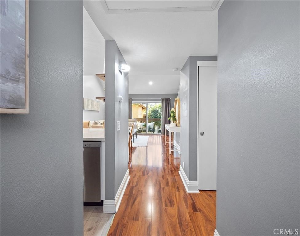 61 Orange Blossom Irvine, CA 92618 - Photo 4 of 40 a view of a hallway with wooden floor and furniture