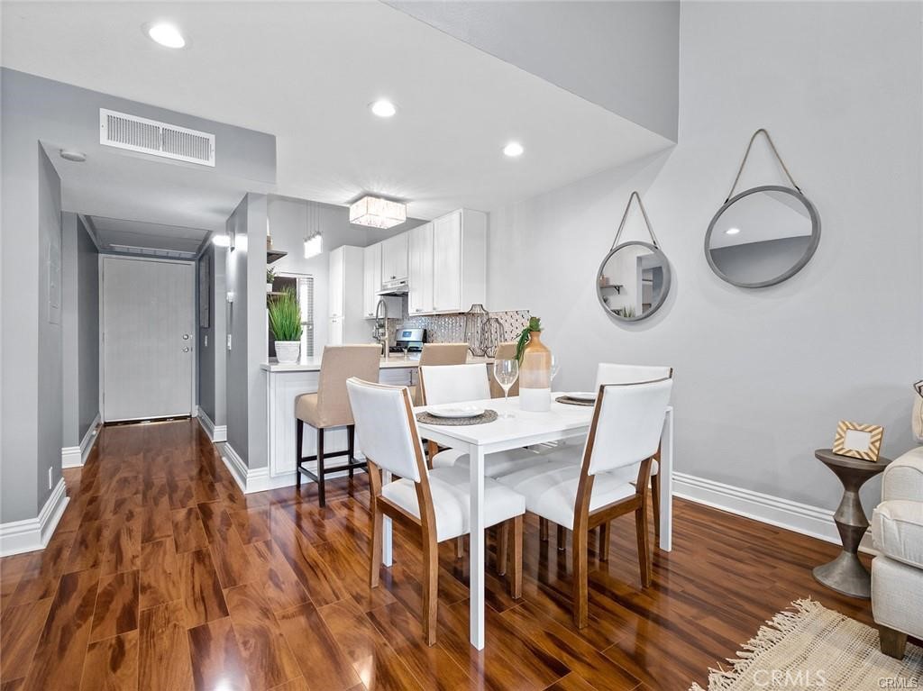 61 Orange Blossom Irvine, CA 92618 - Photo 5 of 40 a view of a dining room with furniture and wooden floor