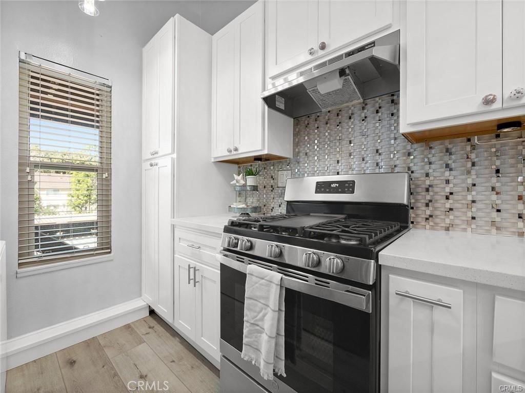 61 Orange Blossom Irvine, CA 92618 - Photo 9 of 40 a stove top oven sitting inside of a kitchen