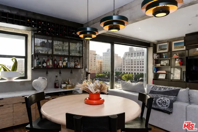 a dining room with furniture a rug and a large window