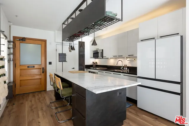 a kitchen with a sink appliances and cabinets
