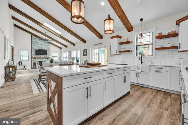 a kitchen with stainless steel appliances granite countertop a lot of counter space and wooden floors