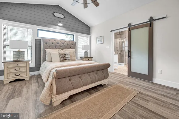 a bedroom with a bed a window and a chandelier