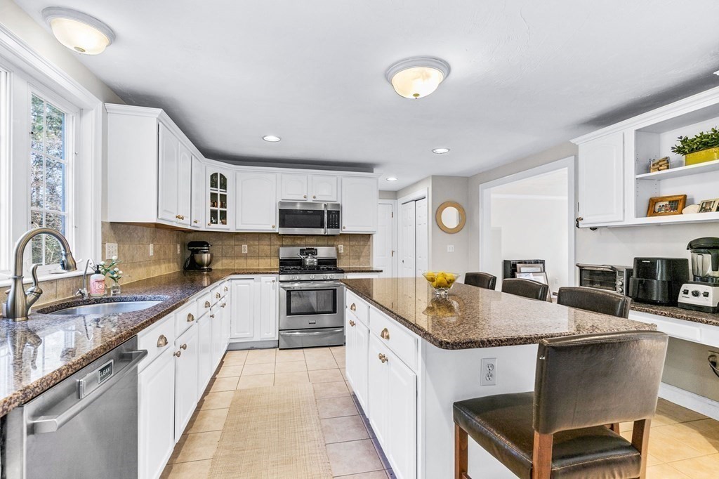 69 Paradise Lane Rochester, MA 02770 - Photo 8 of 38 a kitchen with stainless steel appliances granite countertop a sink dishwasher stove refrigerator and cabinets with wooden floor