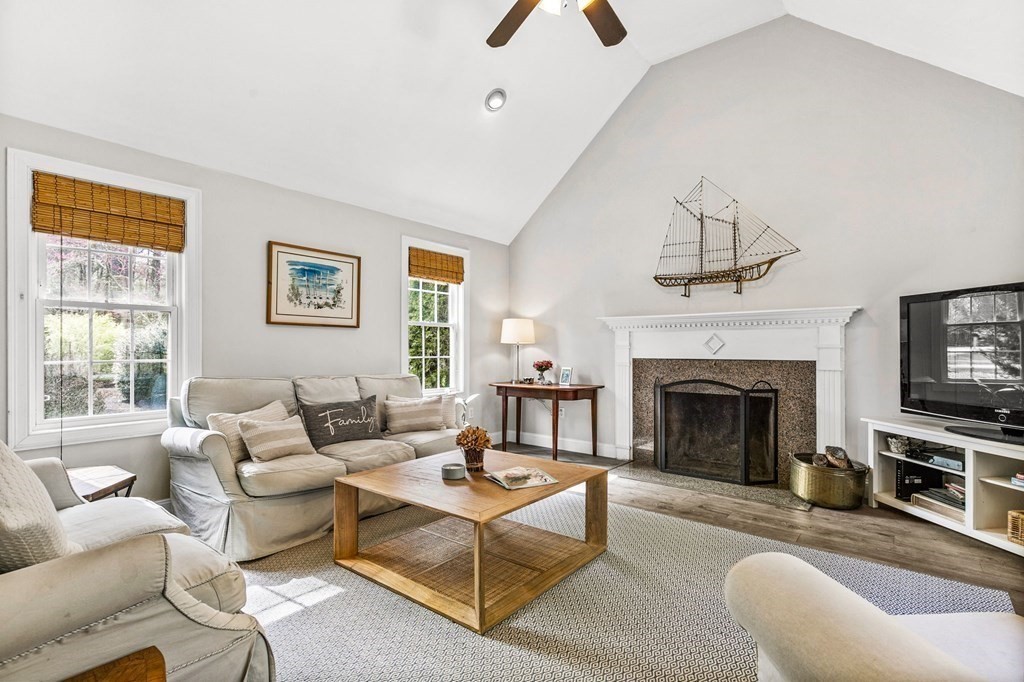 69 Paradise Lane Rochester, MA 02770 - Photo 10 of 38 a living room with furniture a window and a fireplace