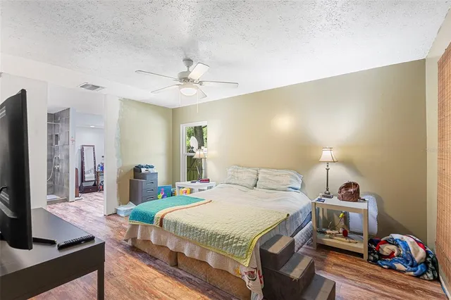 a bedroom with a bed and a flat screen tv