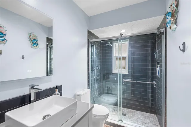 a bathroom with a sink toilet and shower