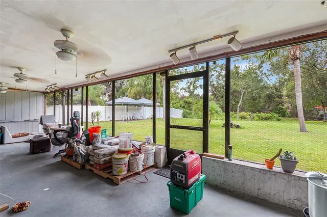 a living room with furniture and floor to ceiling windows
