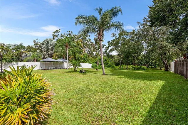 a view of a backyard with a garden and entertaining space