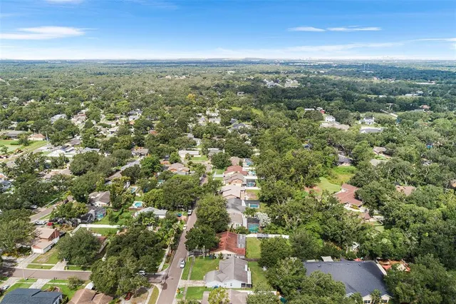 an aerial view of residential houses with city view