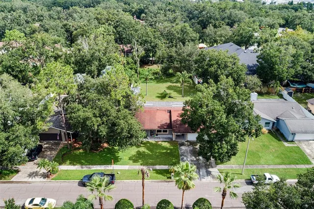 an aerial view of a house with a yard