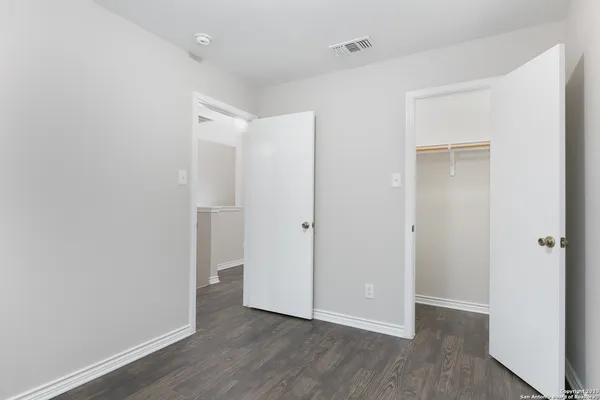 a bathroom with a sink a toilet a mirror and shower