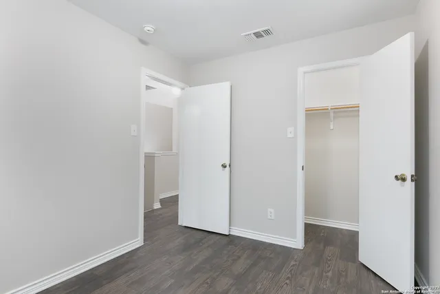 a bathroom with a sink a toilet a mirror and shower