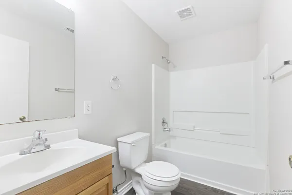 a bathroom with a bathtub and a toilet
