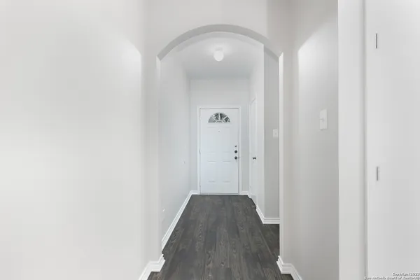 a view of a hallway with wooden floor