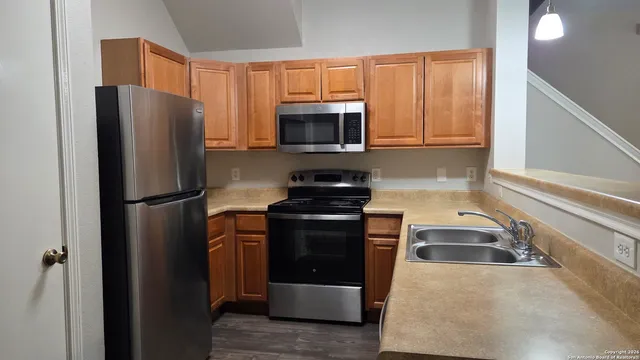 a kitchen with a refrigerator stove and microwave